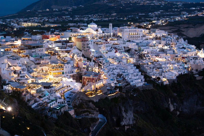 an aerial po of a white town with many lights at night