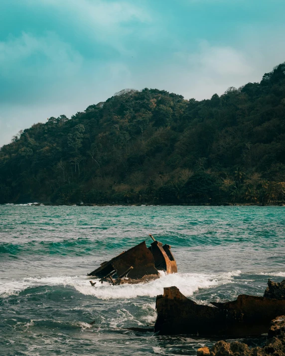 an ocean scene with a mountain in the background