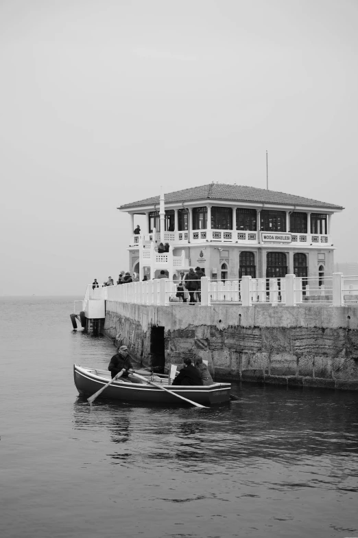 a house next to a dock on the ocean