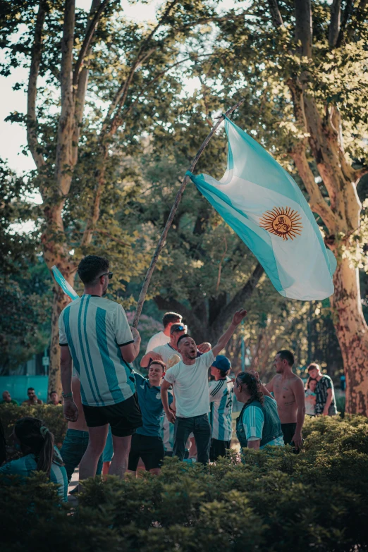 a group of people standing around in a park