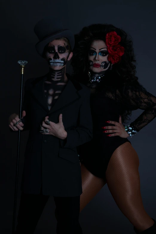 two people dressed as skeleton and skeletons posing for the camera