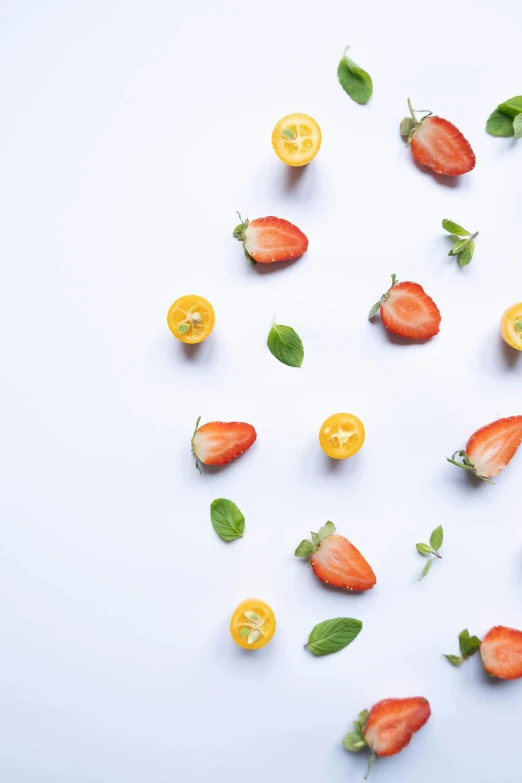 there are oranges and strawberries arranged together