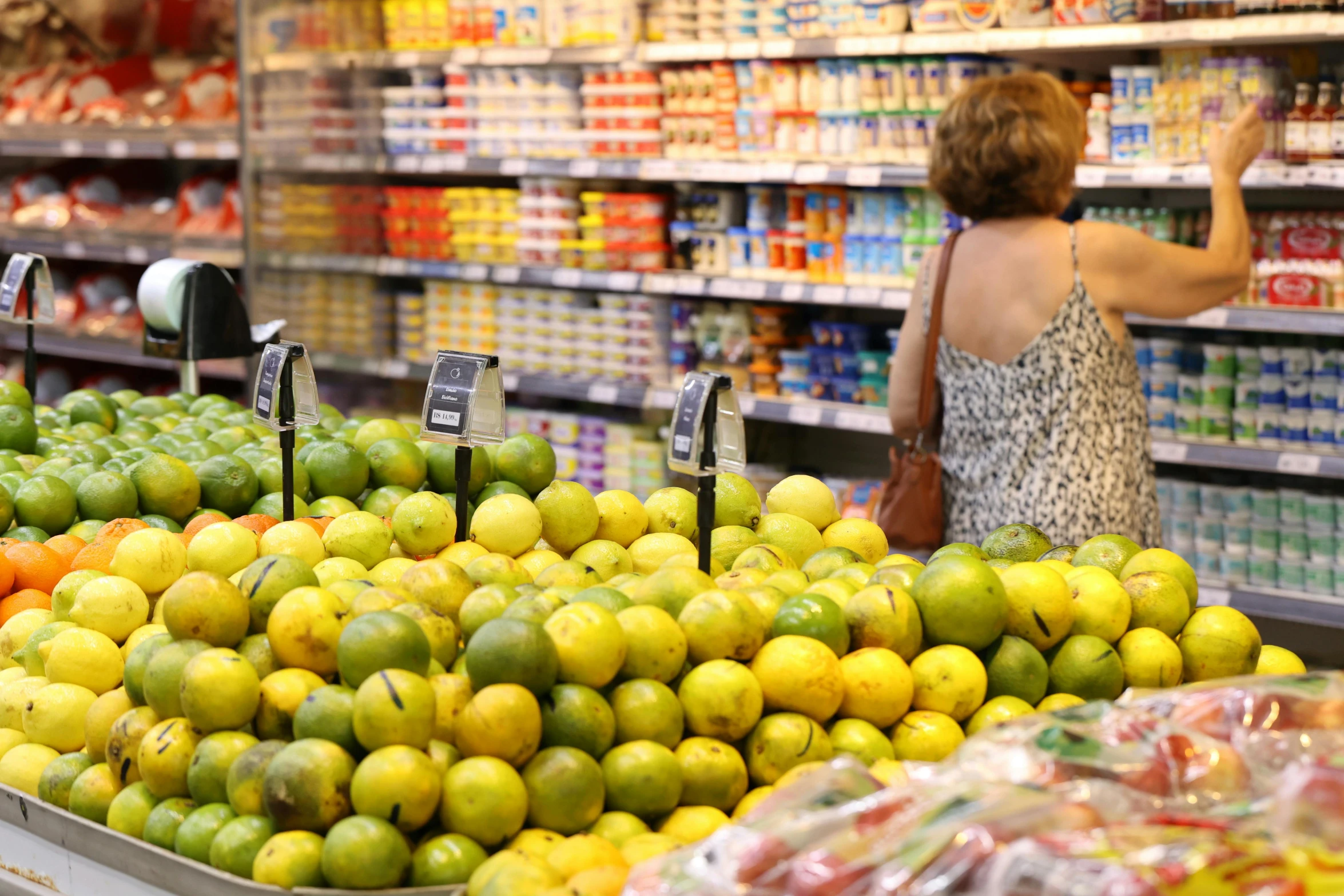 woman shopping in produce section at store