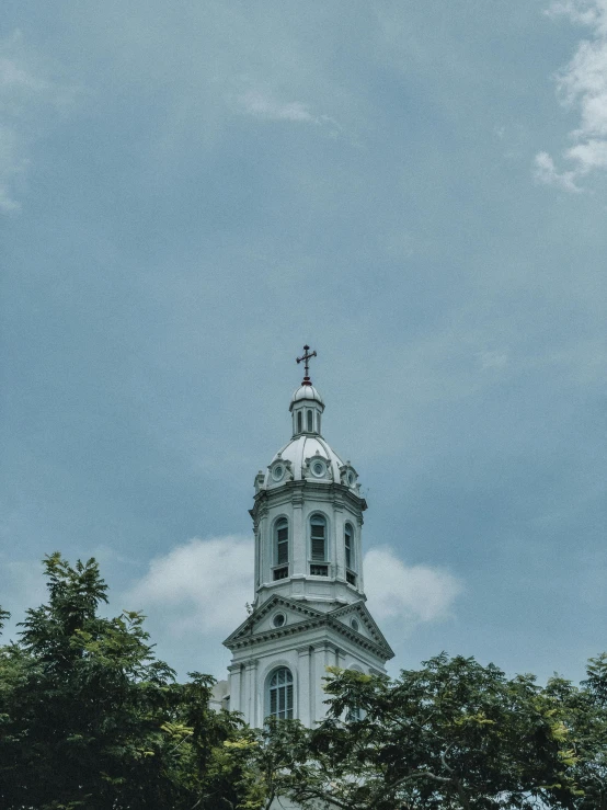 a steeple on top of a building in a wooded area