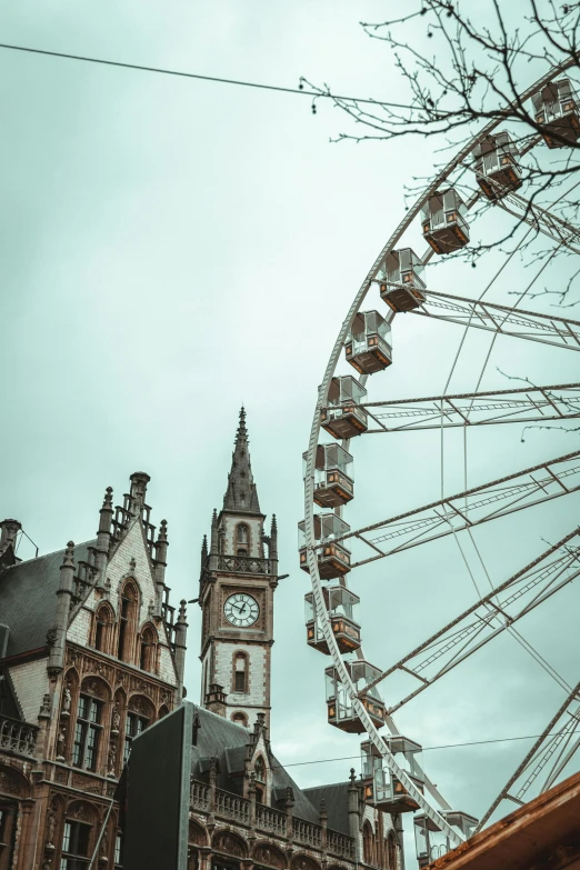 a large ferris wheel behind a building