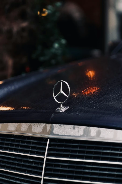 the mercedes badge is placed on a black car