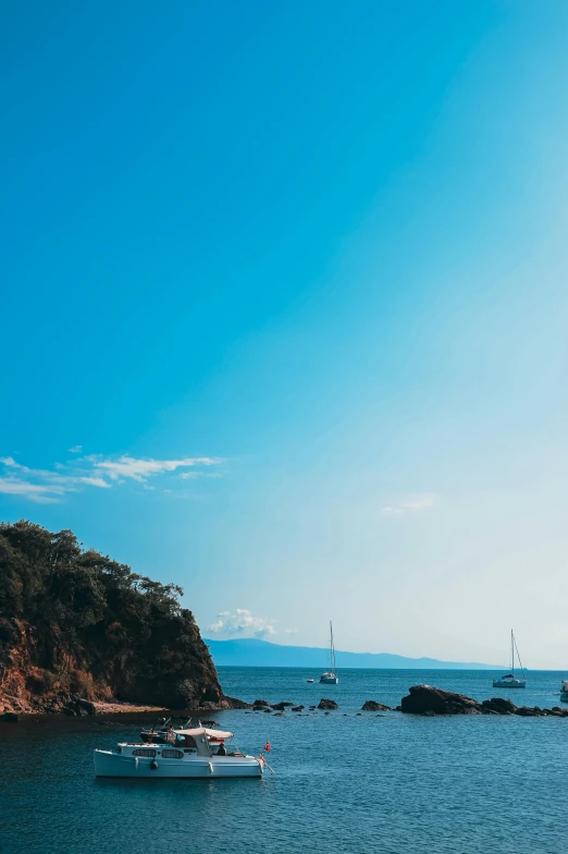 several boats in the ocean near a beach