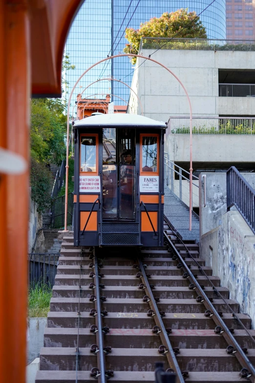 a train car is passing a staircase leading to a building