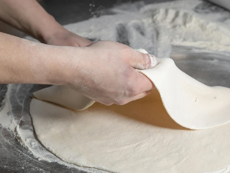 a person is making dough using a spatula