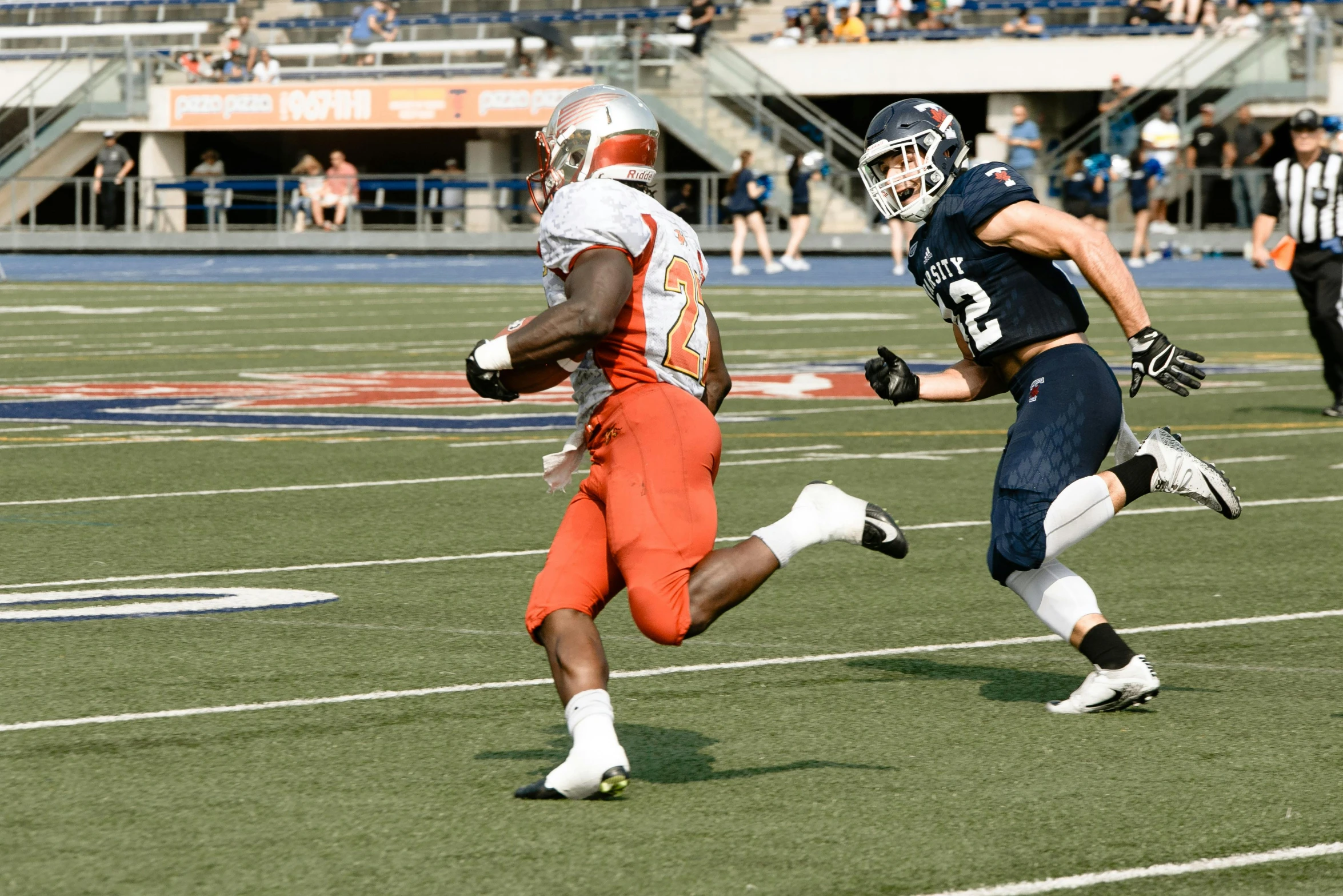 the man in the uniform is running the ball