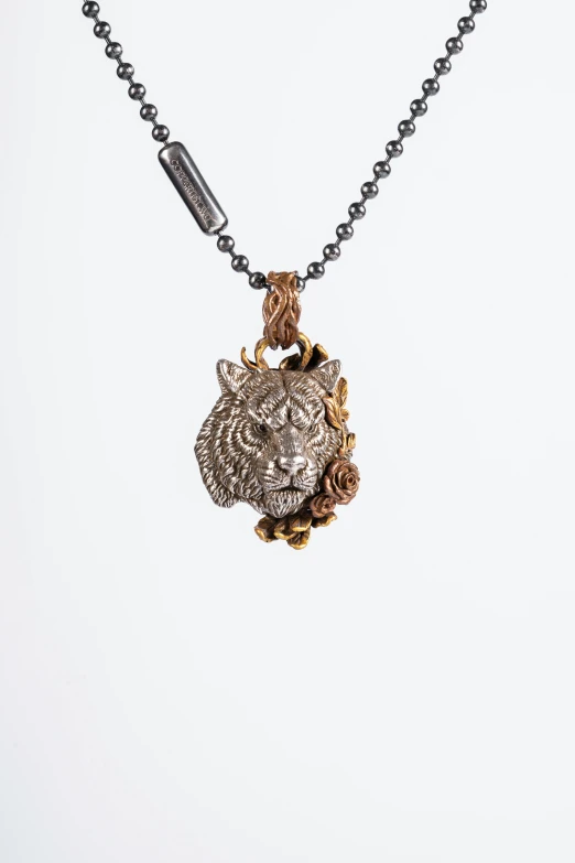 a gold and silver necklace with a fancy head design