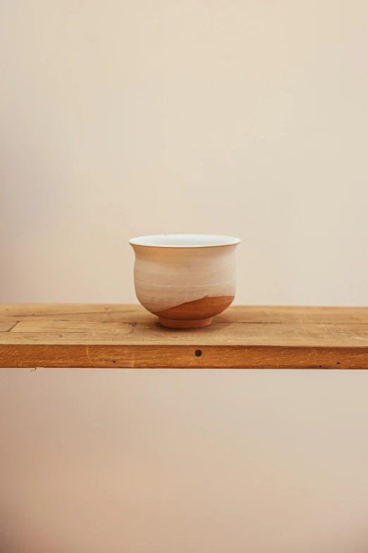 a white bowl with wood in the middle