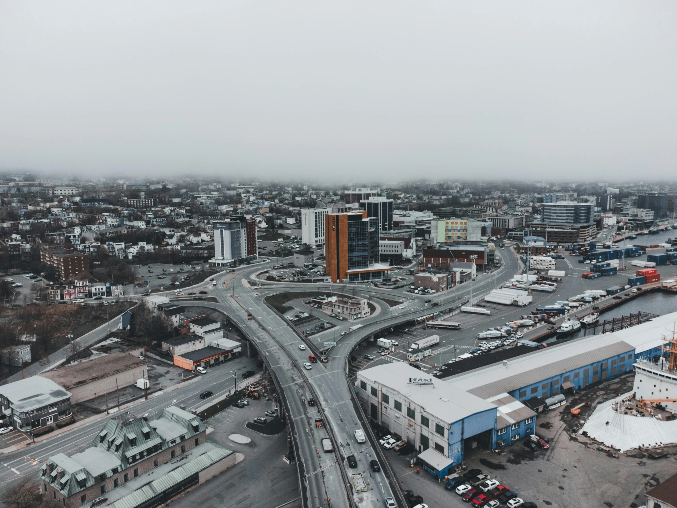 aerial view of city and roadway intersection with many traffic