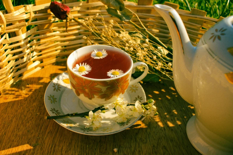 tea pot on wooden table with red and yellow floral design on it