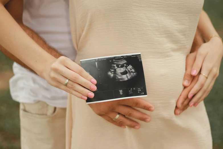 a pregnant woman is holding her baby bump in the belly