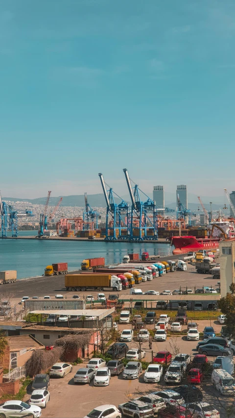 a large port filled with cars and large cranes