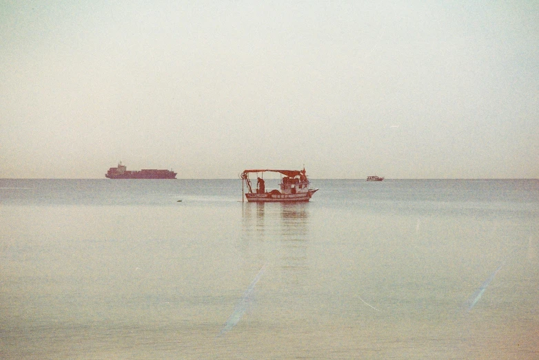 a group of people sitting in a boat out on the ocean