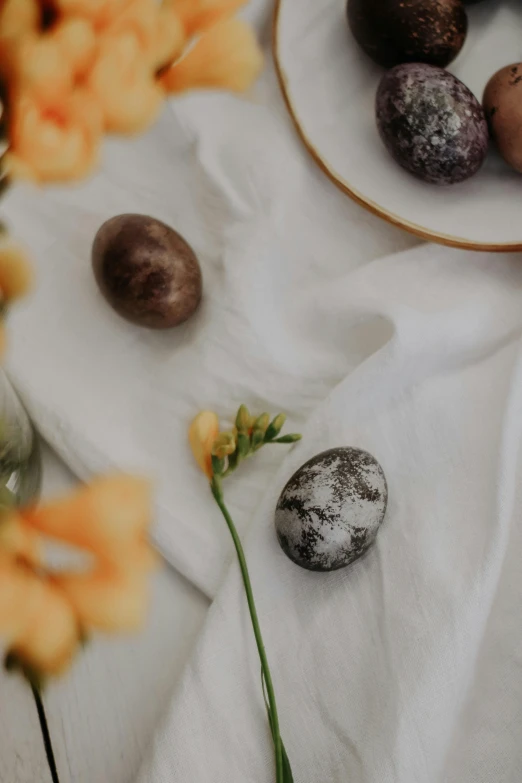 some quails are on a plate and there is flower