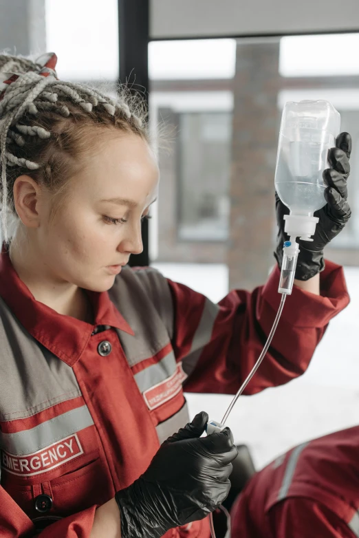 woman with dreadlocks is setting up a device to test the volume