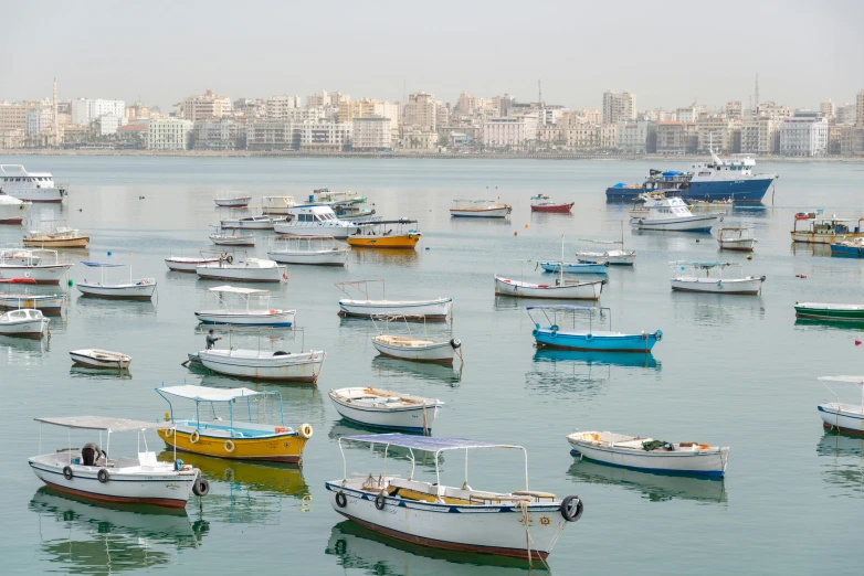 there are many boats floating on the water in this city