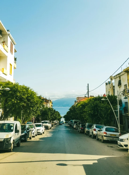 cars parked on the side of a small street