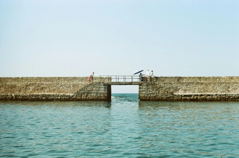 an open dock with people standing on it and fishing