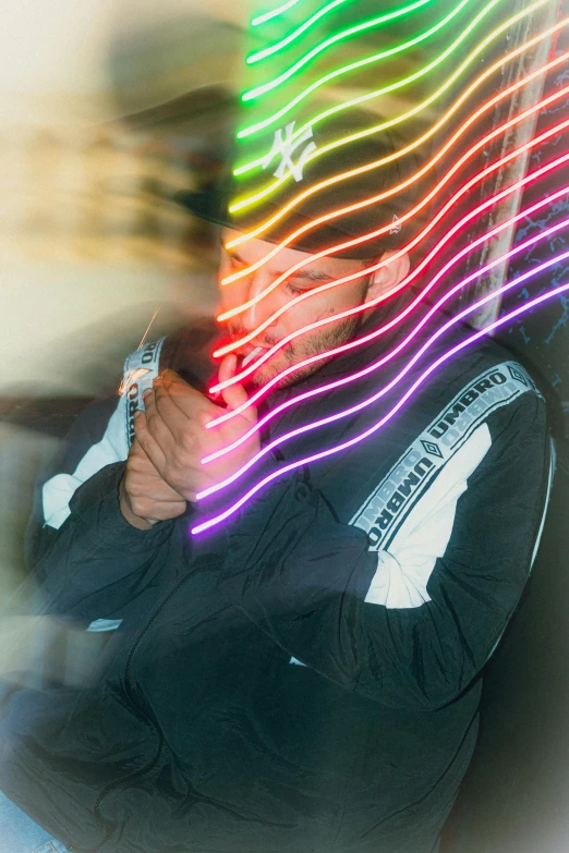 a man in black is leaning against a wall holding his arms around his face