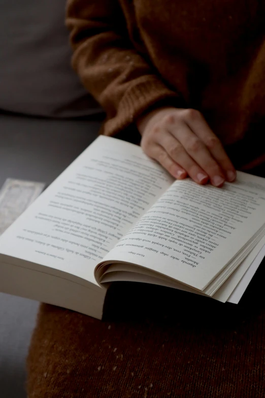 a woman reading a book from her lap