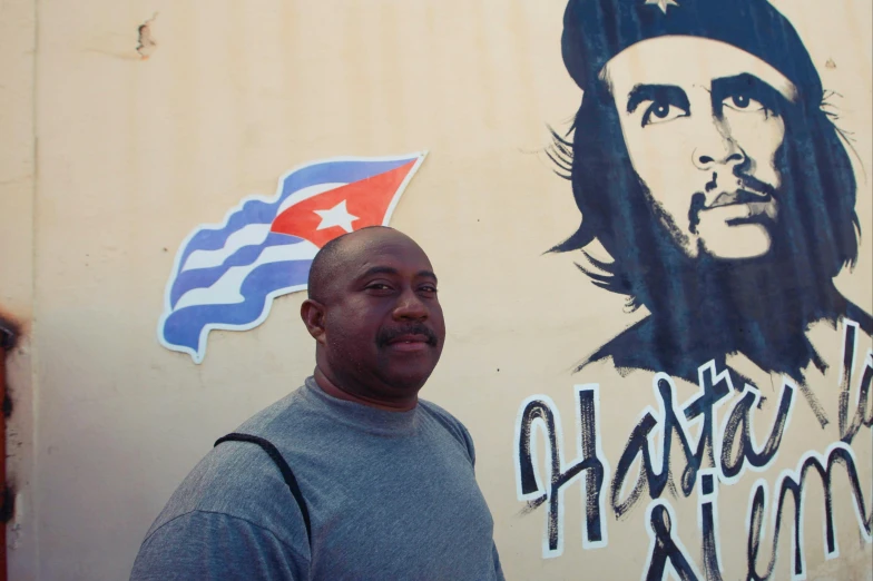 a man is standing in front of some graffiti