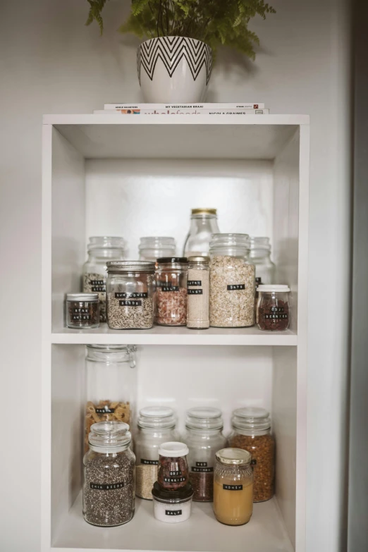 the shelves have spices in glass jars