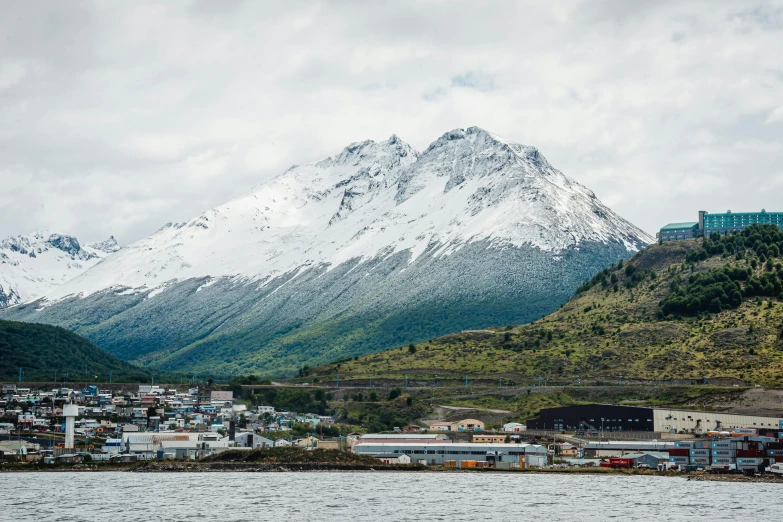 a very snowy mountain in a small town near the water