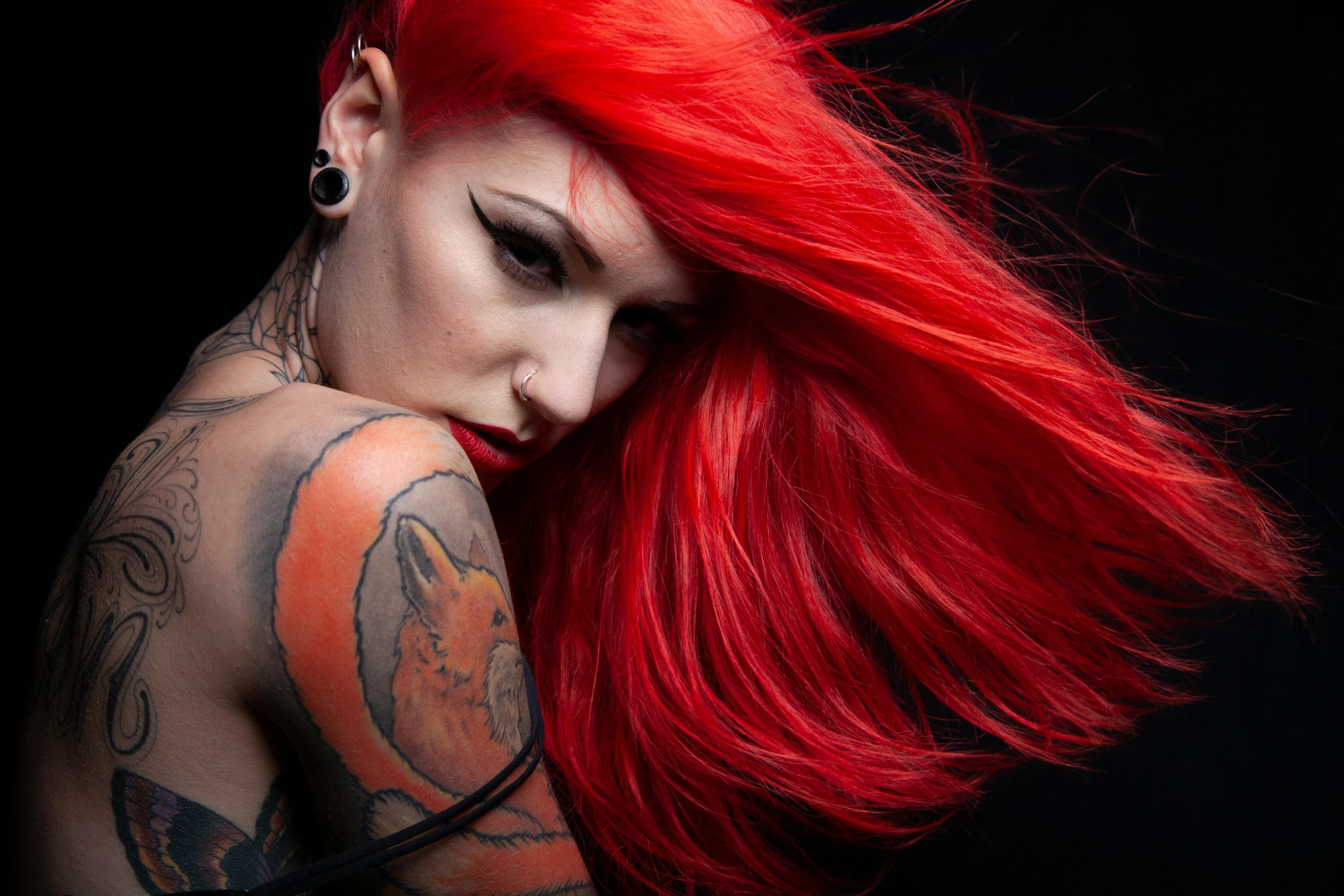 a woman with long red hair is looking down