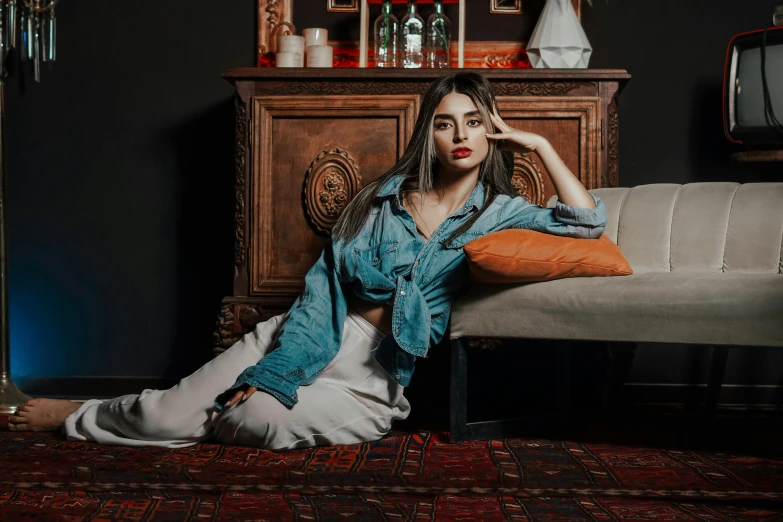 a woman is sitting on the couch with her feet up