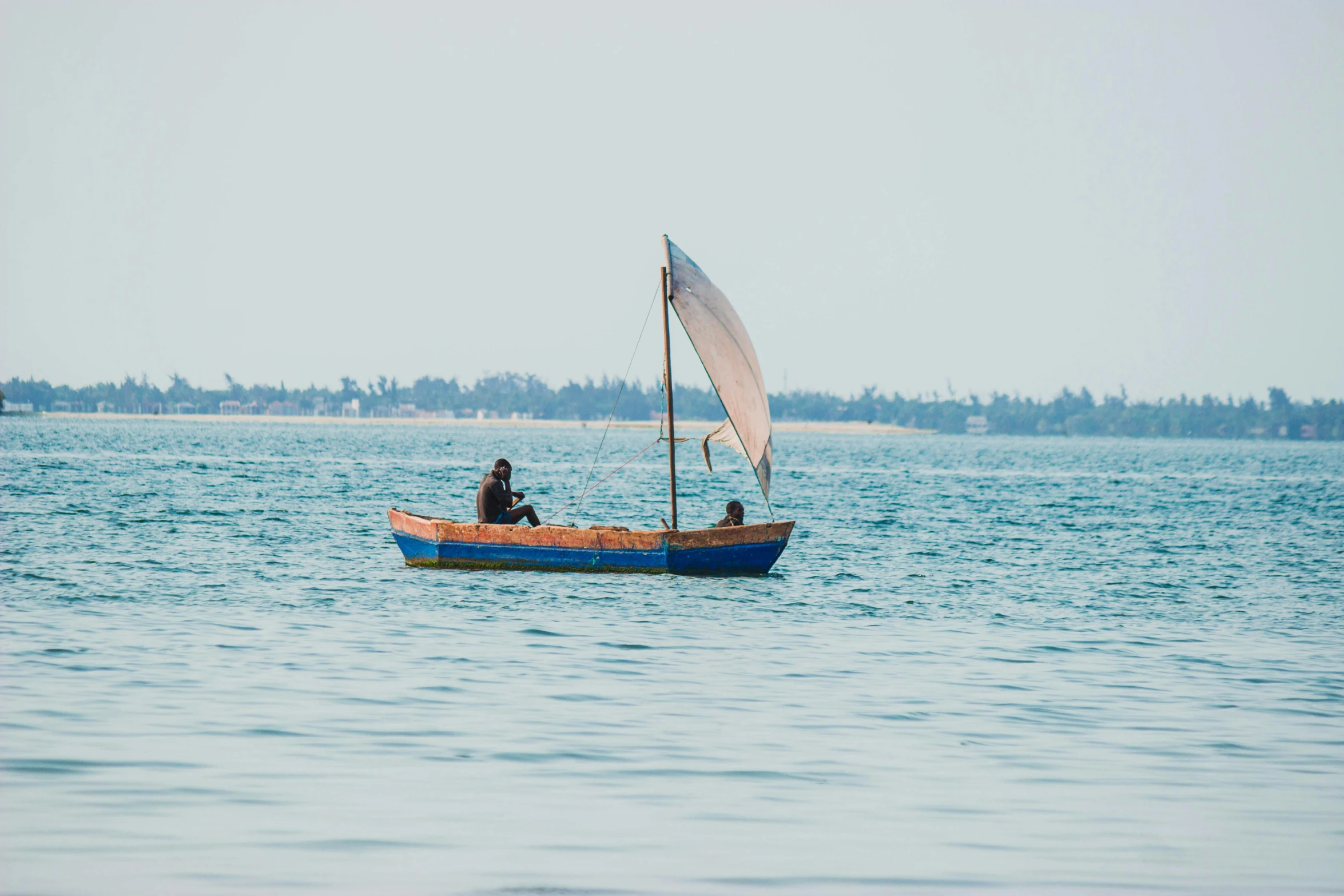 a person sits on a boat in the middle of the ocean