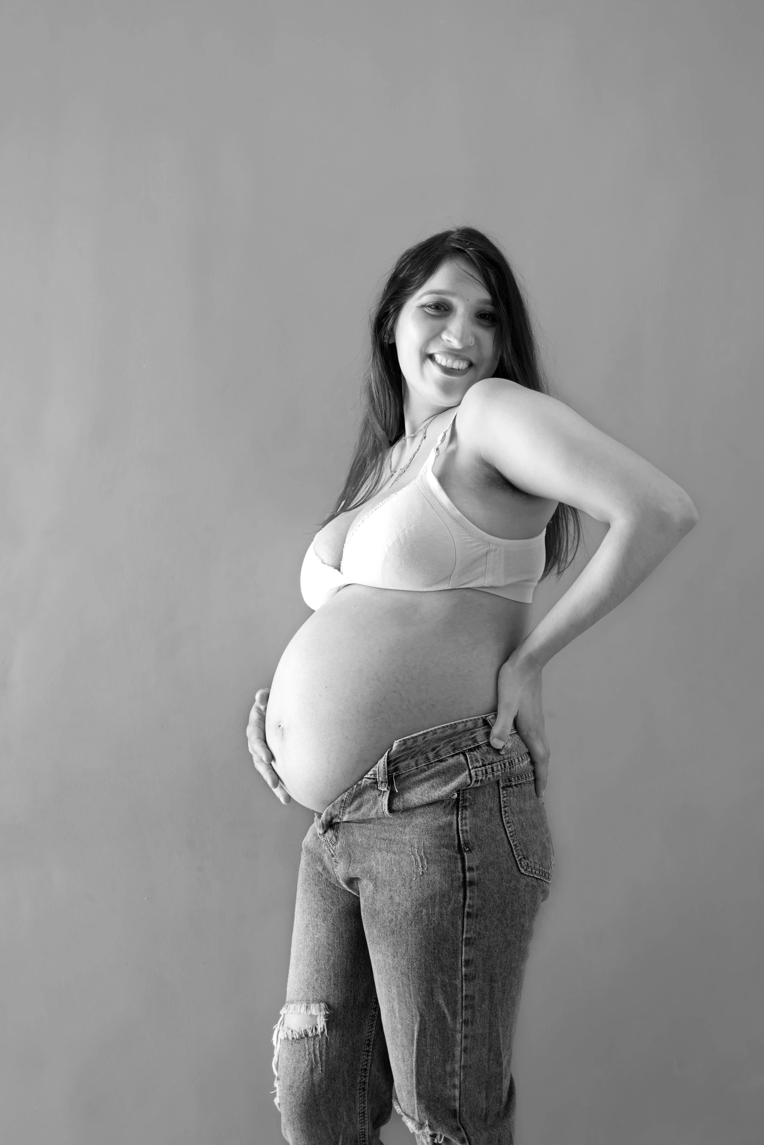 a pregnant woman with her hands on her hips