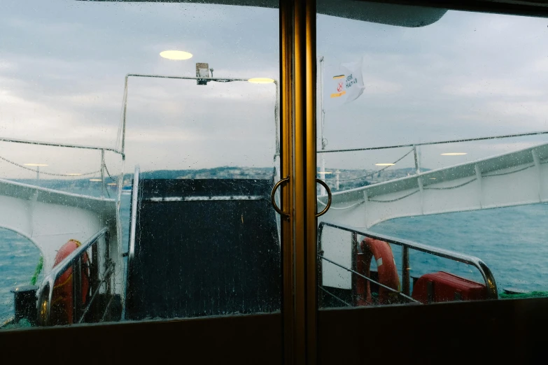 a view of the deck of a ferry on a rainy day