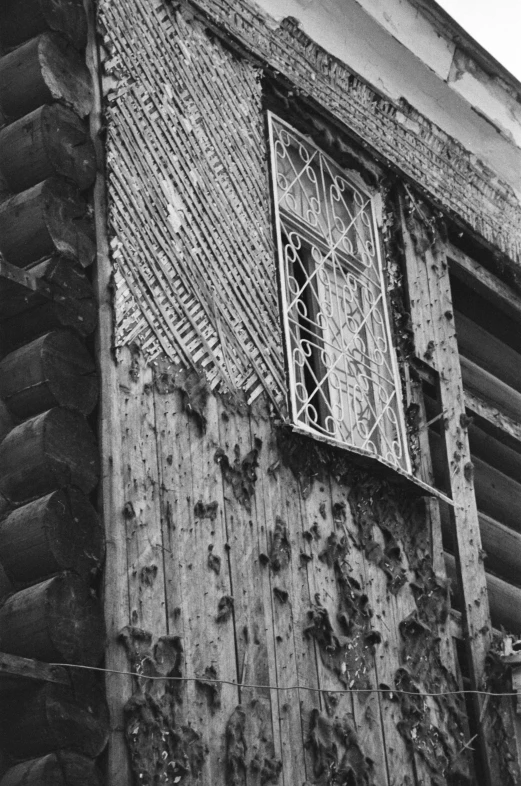 black and white pograph of a window of an old building