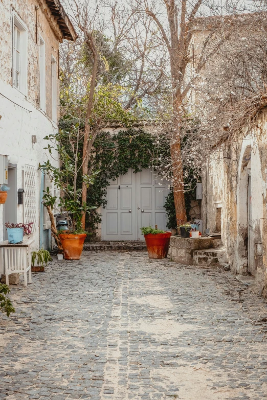 an alley way with white houses and doors