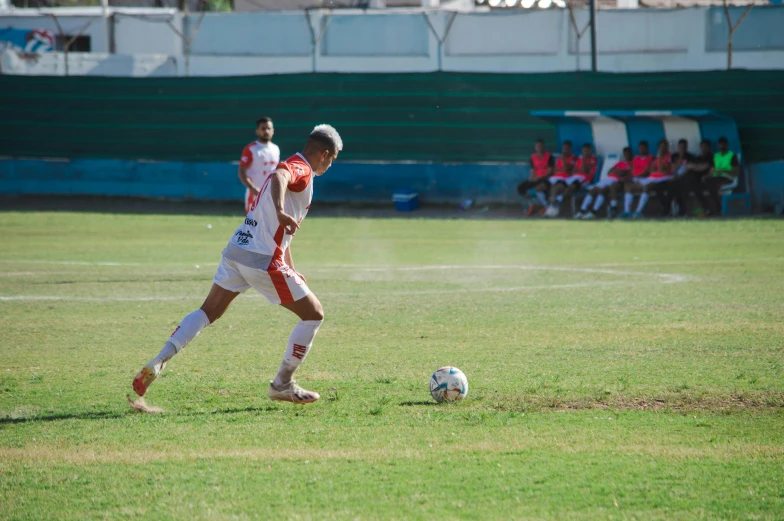 an image of soccer player about to kick the ball