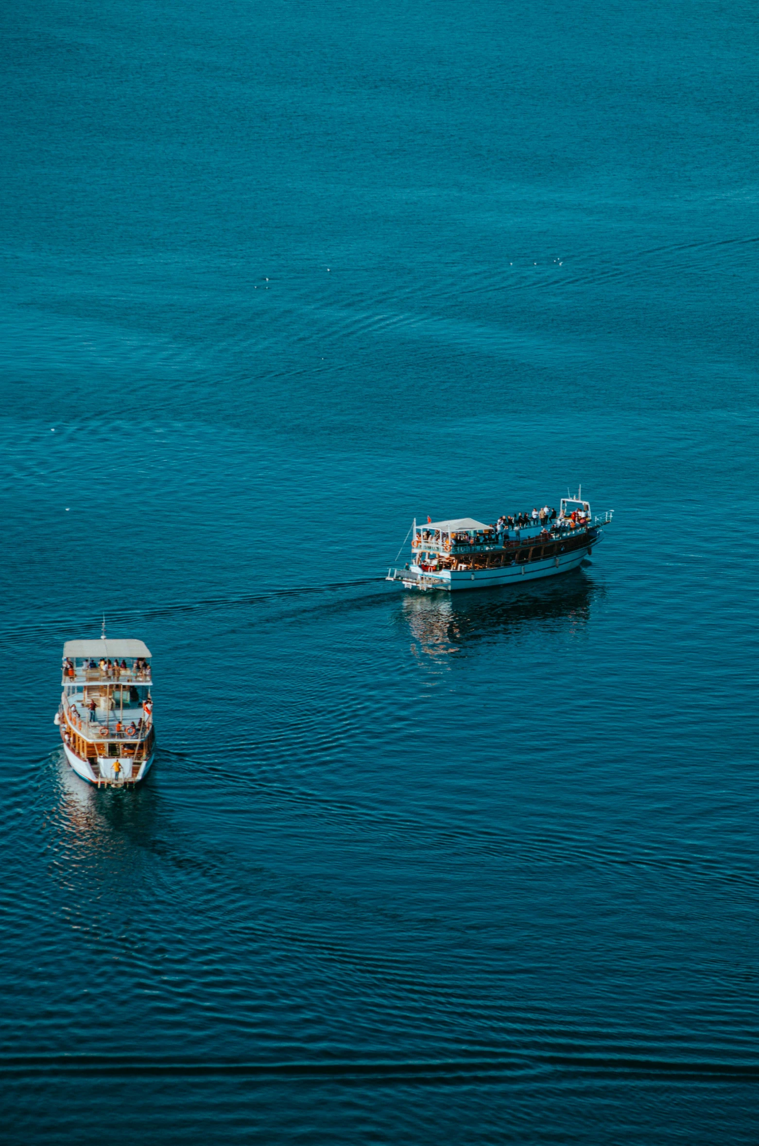 a white and orange boat and a red and white boat and a brown boat