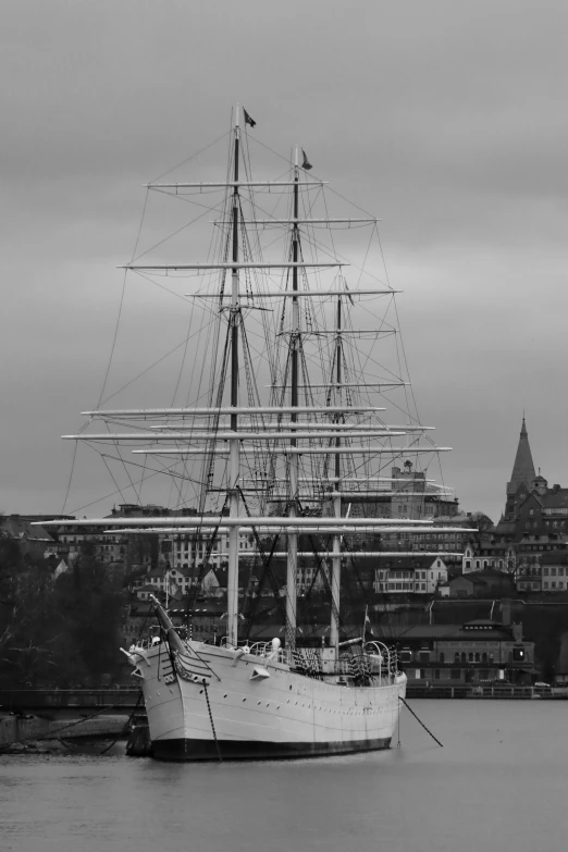 the large sail boat is docked in the harbor