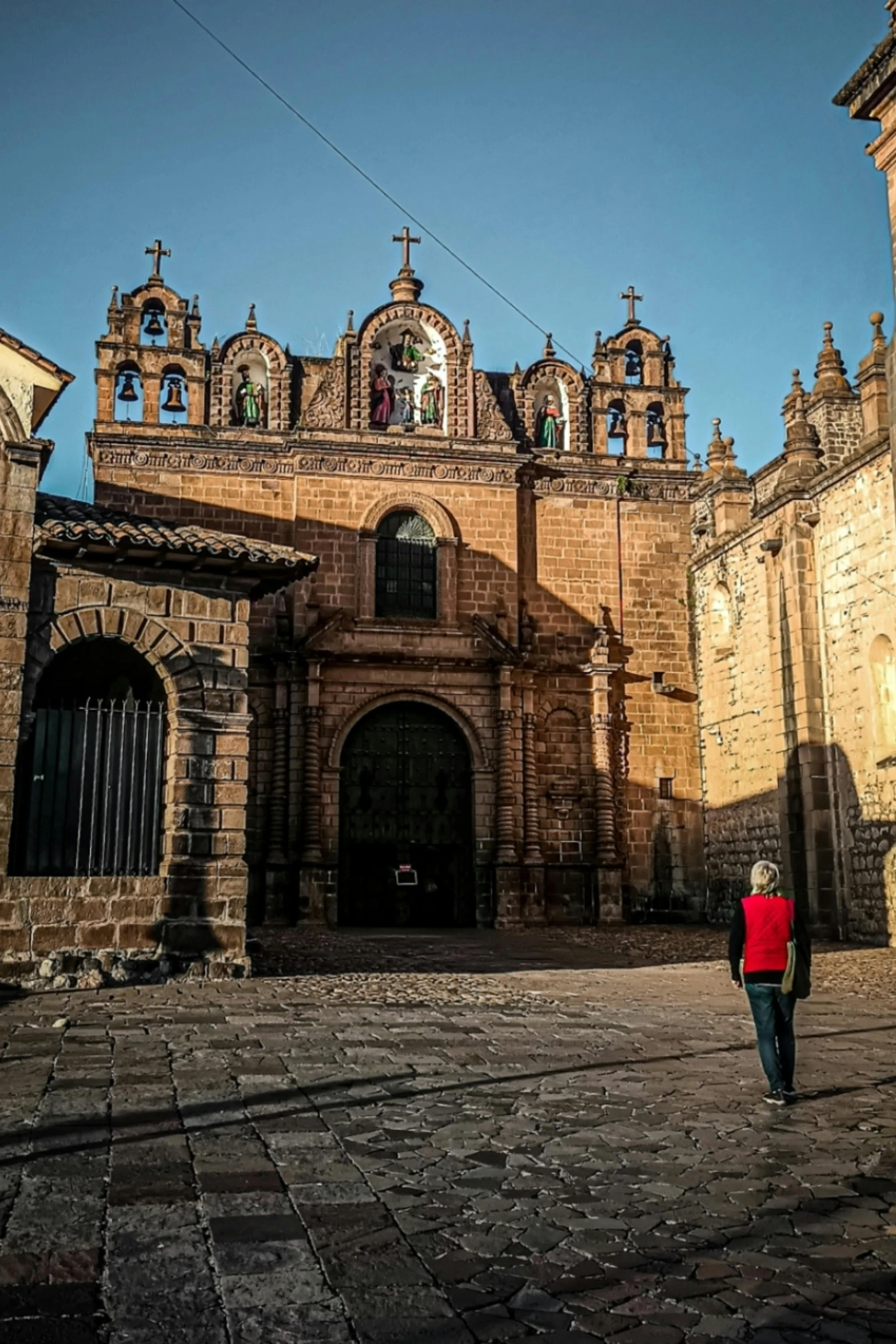 a woman standing in the middle of an old street