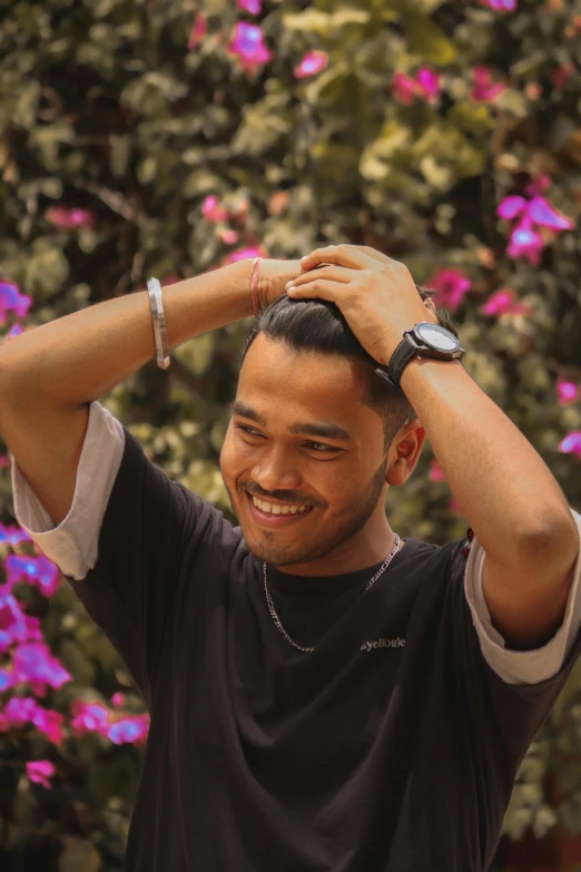 a man smiling holding his head up