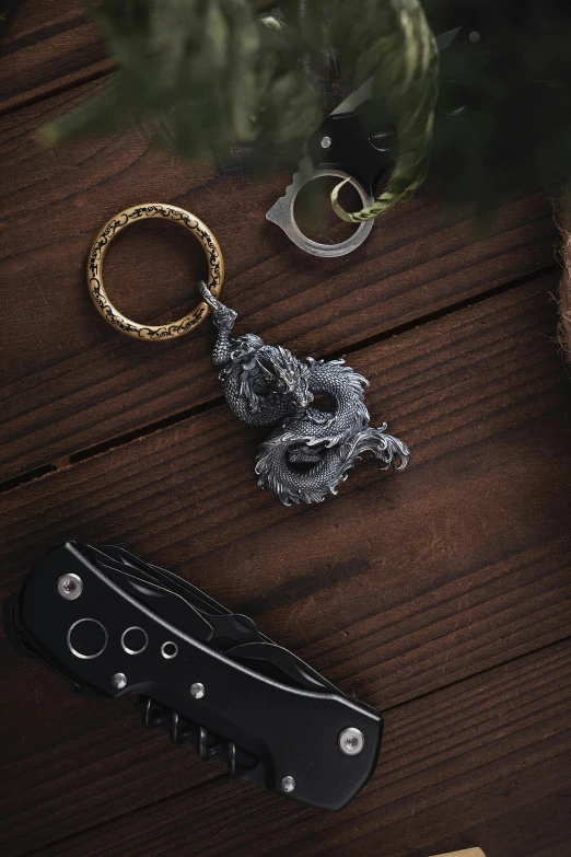 different accessories on a wood table including a knife and a watch