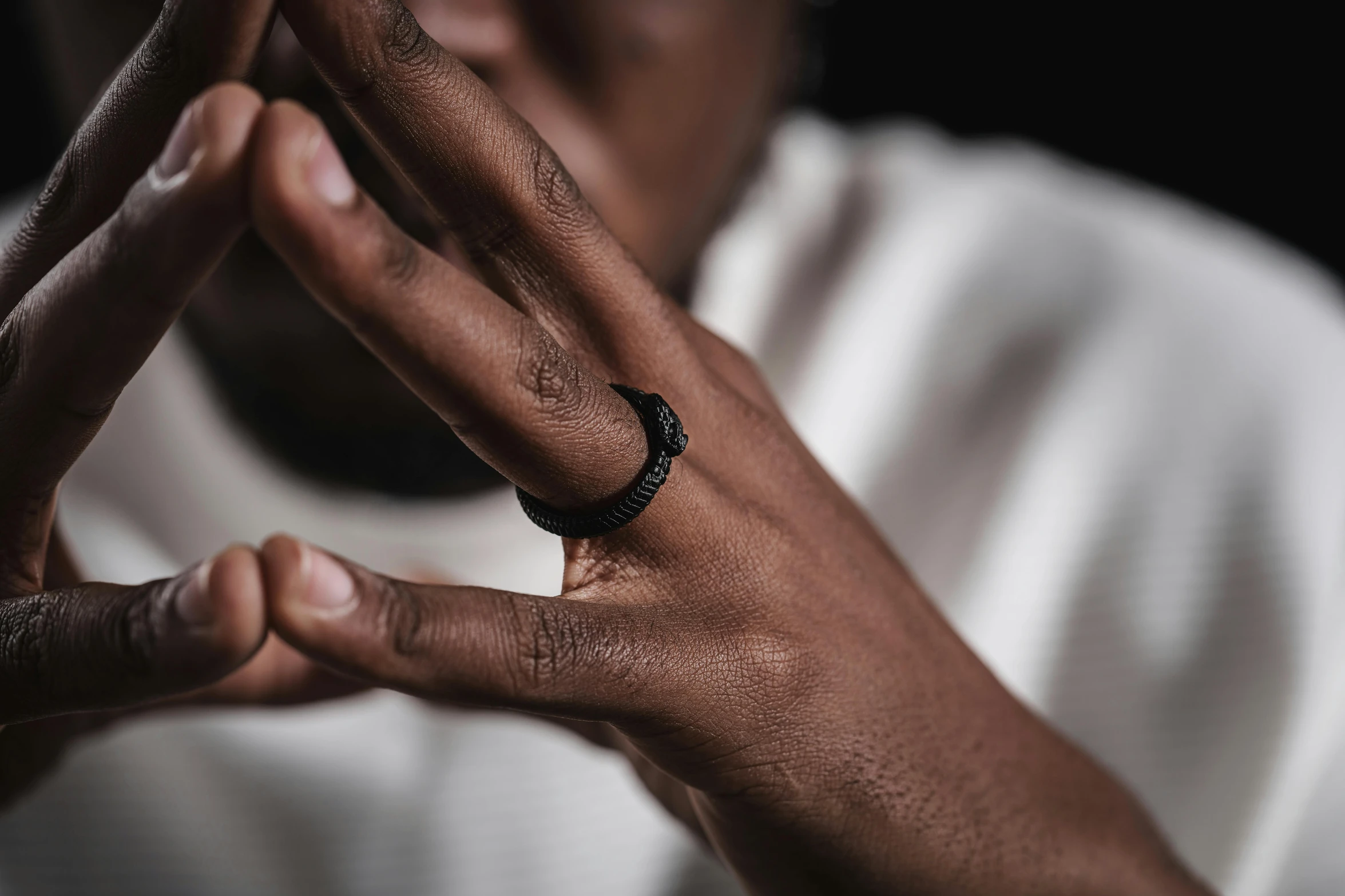 a close up of a person making a peace sign