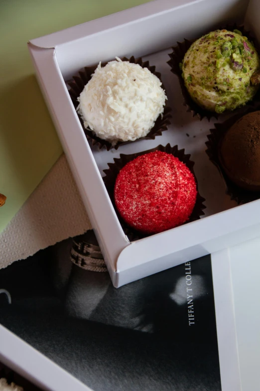 a box with three different types of cupcakes
