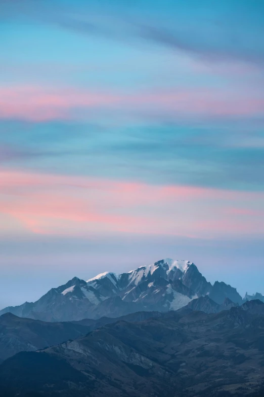 a white snowy mountain range in the distance under a blue sky