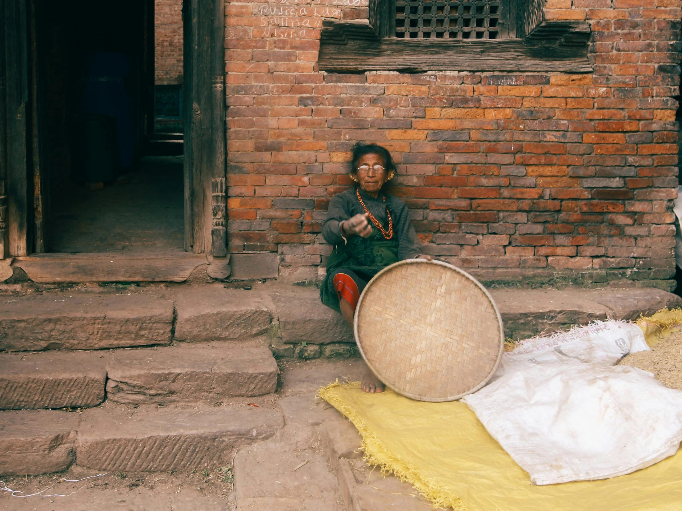 an indian woman sitting on some steps by a big chair