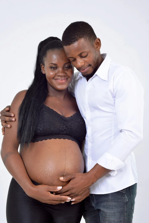 an adult black couple pose for the camera