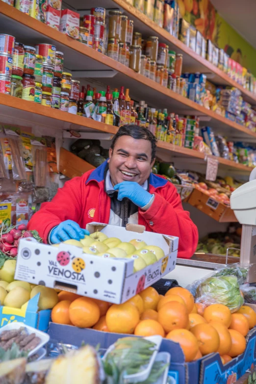 a man in a grocery store holding up boxes